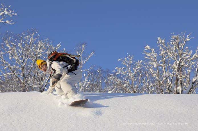 雪板で滑走する男性