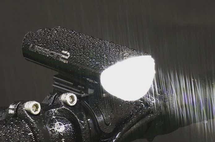 雨の中で灯りを灯す自転車のライト