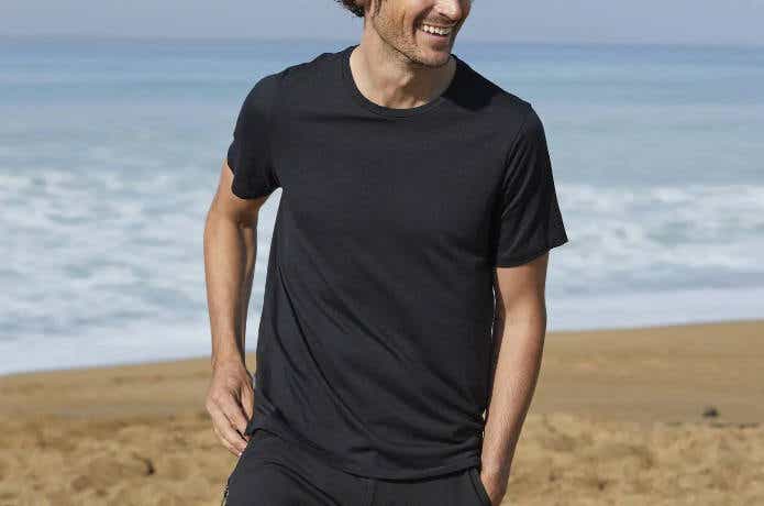 浜辺で半袖のメリノウールインナーを着ている男性