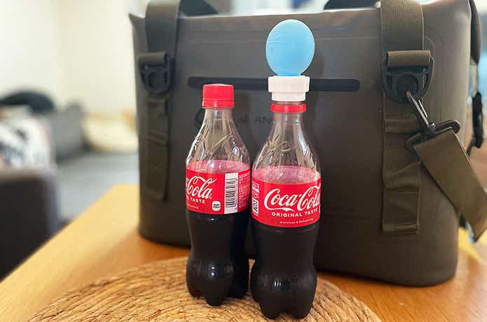 ダイソー「炭酸キープキャップ」を装着したコーラとクーラーボックスの高さ比較