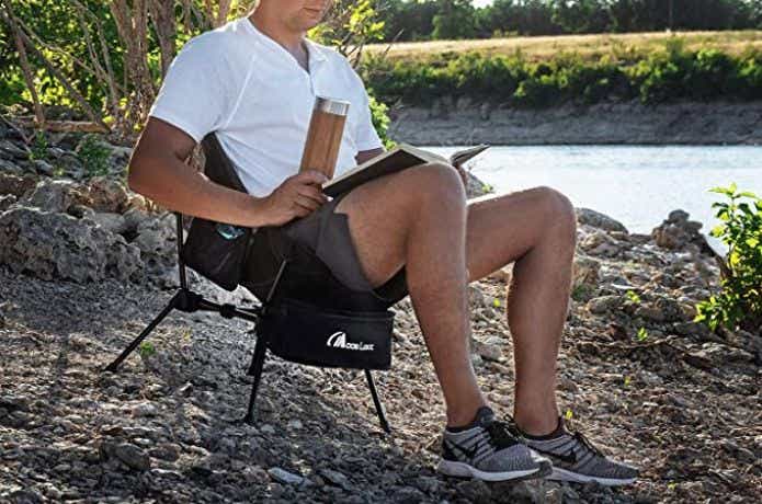 湖のほとりで椅子に座って本を読む