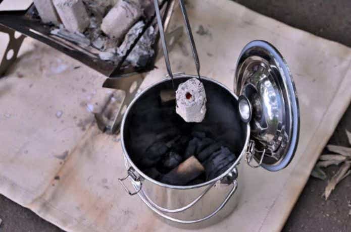 炭が入った火消し壺に炭を入れる