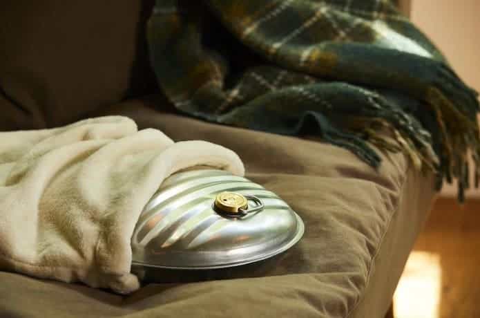 マルカの「湯たんぽA2.5L袋付」がソファに置かれている