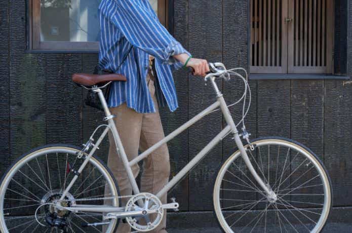 ベージュの自転車を持つ人