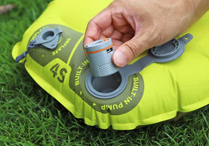 タイニースリーピングマットに付属の電動ポンプで空気を入れる