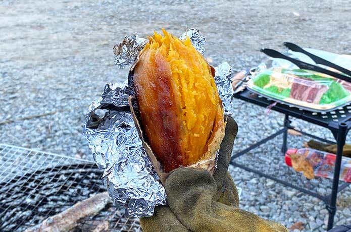 手に持った炭火で作った焼き芋