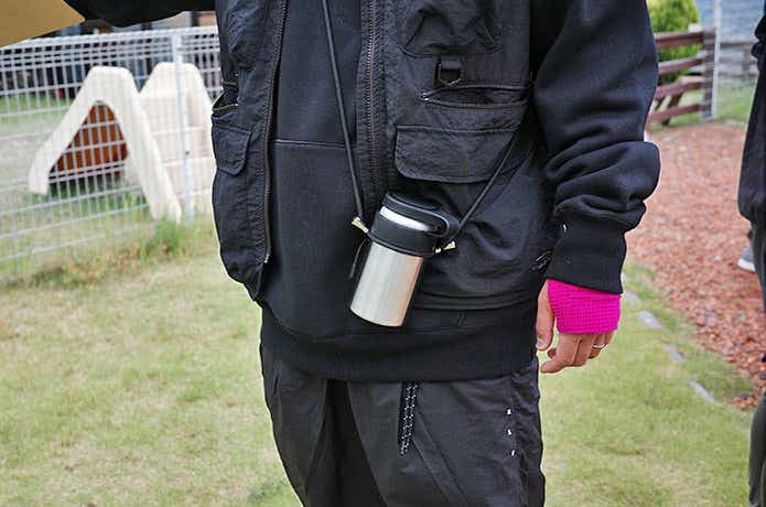 肩にかけた缶ビールの入ったCan Holder
