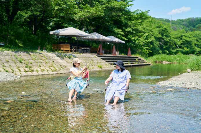 川で遊ぶ半袖の女性